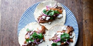 How to Make Easy Vegetarian Chipotle Mushroom Tacos Chipotle Mushroom Tacos topped with cheese and onions