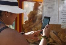 Tech Tips for Food & Travel Content Creators on the Go travel content creation tips woman holding cell phone