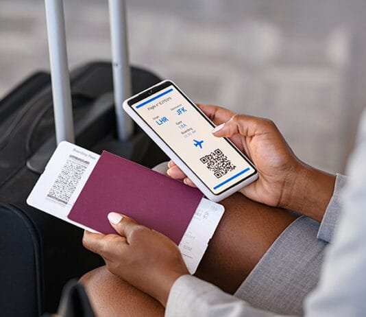 Digital Safety Essentials for Every Traveler vpn for travel woman holding passport and mobile phone