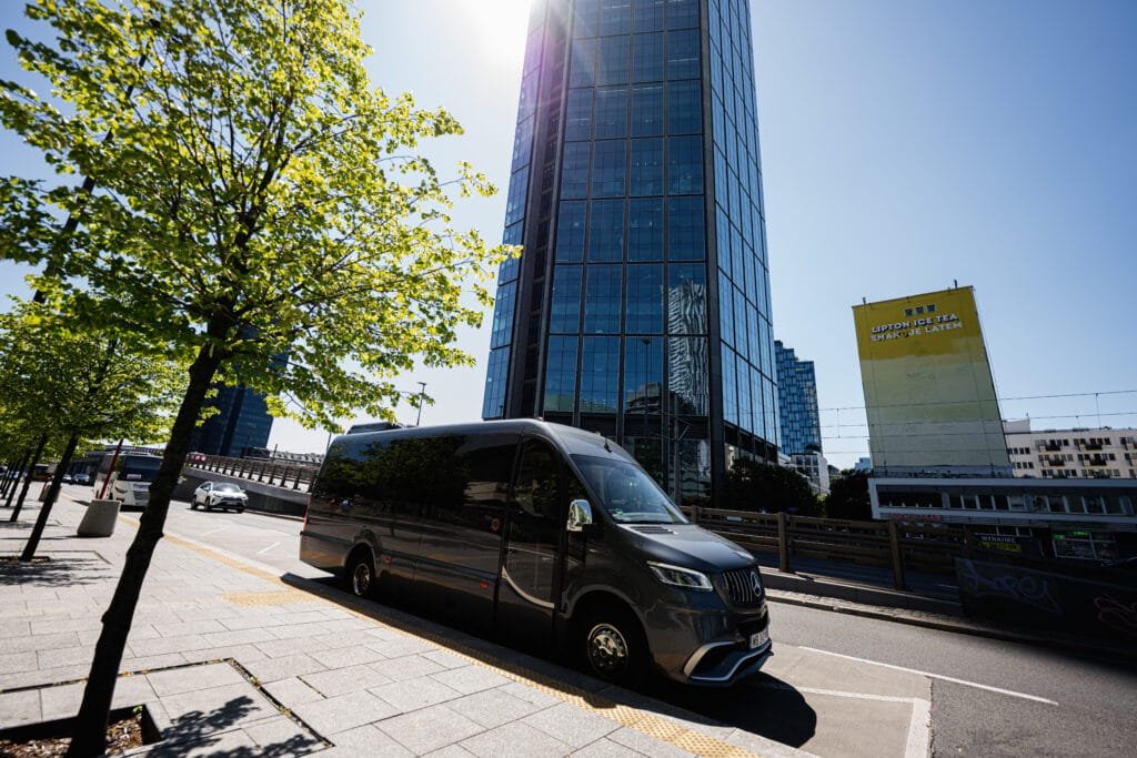 How to Rent a Van Without Breaking the Bank ray Mercedes-Benz Sprinter 519 Bus Factory Luxury Line van on a city street with modern architecture in Warsaw, Poland